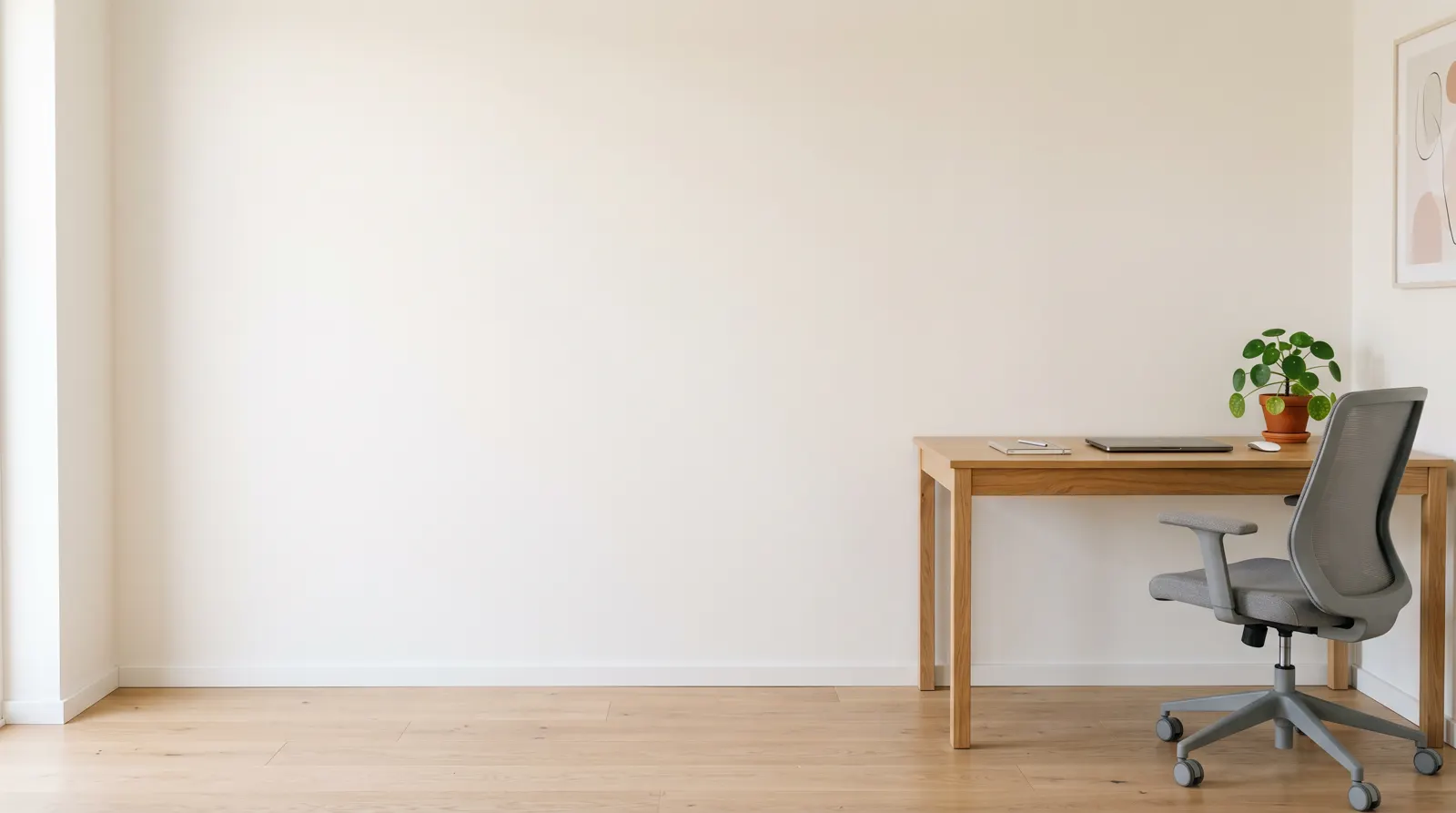 Ergonomischer grauer Bürostuhl an einem Holzschreibtisch in einem hellen Homeoffice (Symbolbild)